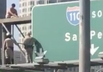 Man in Underwear Taken into Custody After Climbing 110 Freeway Sign in Protest