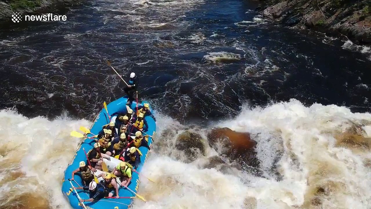 White-water rafting guide gets tossed out of boat after hitting big wave