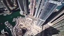 فيديو شاب مجنون يقوم بحركات انتحارية فوق أحد الأبراج الشاهقة في دبي