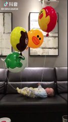 Funny baby playing with balloons