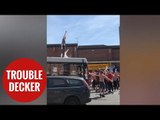 England fans celebrating by surfing on a bus