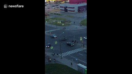 Teenagers bounce on trampoline in middle of busy road