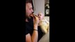 Baby is completely fascinated by father eating a pizza