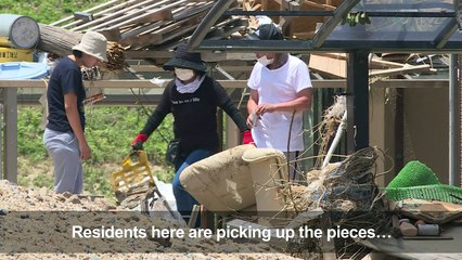 Residents clean up homes as Japan flood death toll rises