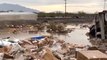 Packages Strewn Beside Flooded Track as Rain Causes Train Derailment in Arizona