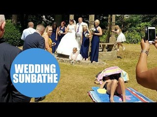 A shameless sunbather photobombs happy couple's wedding pictures