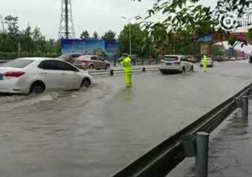 Chengdu Police Direct Traffic as Rain Floods City Streets