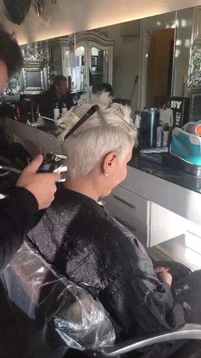 cutting women's short hair with clippers