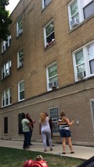 Toddlers Dangling out of Second Floor Window