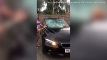 Angry wife takes a sledgehammer to her husband's BMW when she discovered he had been cheating on her