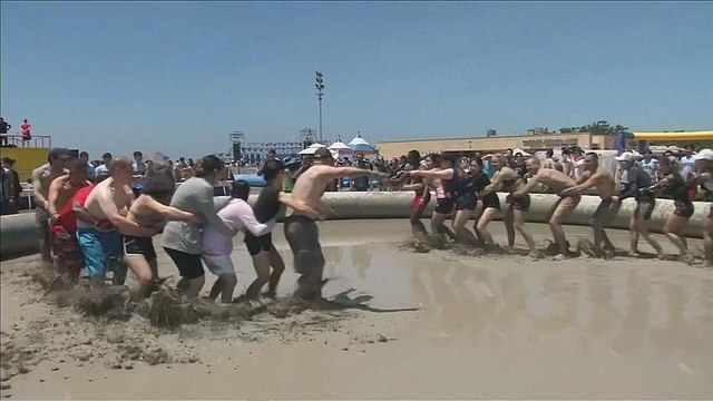 Revellers jump into sludge at South Korea's annual mud festival