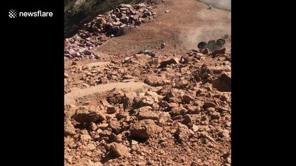 Biker takes hard tumble into rocks after losing control of motorcycle