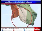 Chennai - Torn National flag flying near war memorial