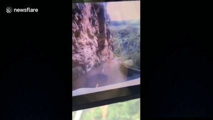 Huge boulder lands on moving car in southern China