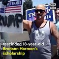This wrestler lost his college scholarship after he was seen yelling a homophobic slur while holding a Trump sign at a pro-immigrant rally