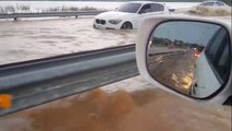 Cars struggle through flooded road in the Philippines