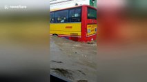 Buses struggle as Philippines storms turn road into raging river