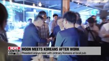 S. Korean President Moon Jae-in enjoys a cold glass of beer with ordinary Koreans at a downtown pub