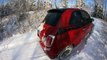 new fiat 500 driving out a steep icy drive way with 7 inches of fresh snow.