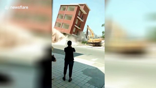Demolition accident as building falls wrong way and crushes excavator