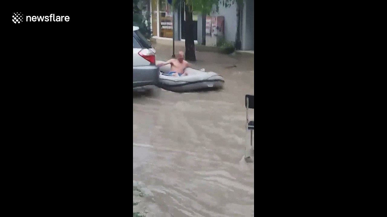 Summer rain in Bulgaria sees people take to the streets in dinghies