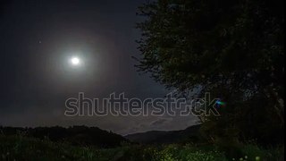 Timelapse slider moving on beautiful night Landscape with full moon with green meadow