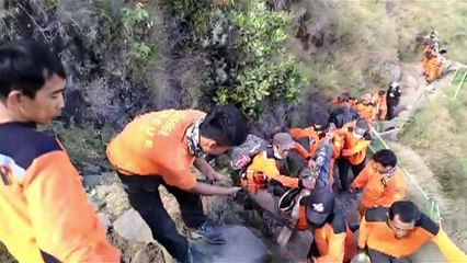 Rescuers carry body from volcano summit after Indonesia quake