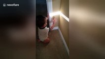 Adorable moment baby discovers his shadow