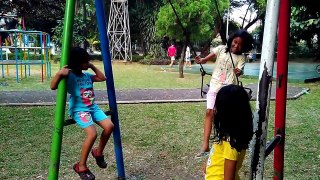 The kids play swing with friends at the park Happy Kids without gadgets