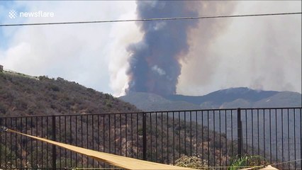 Incredible video shows small spotter plane guiding huge air tanker in Holy Fire air attack