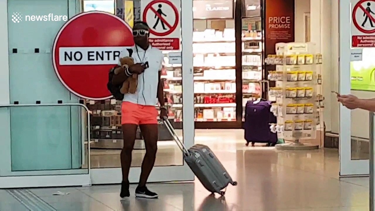 Eccentric man dances through arrival gates at Stansted airport