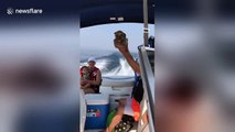 Adorable puppy on a boat moves his paws in swimming motion