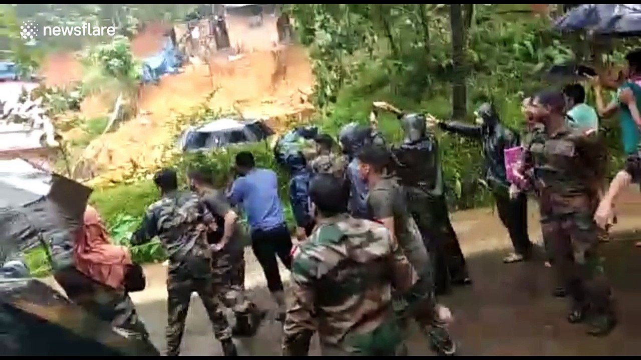 Horror moment villagers watch landslide burying their homes