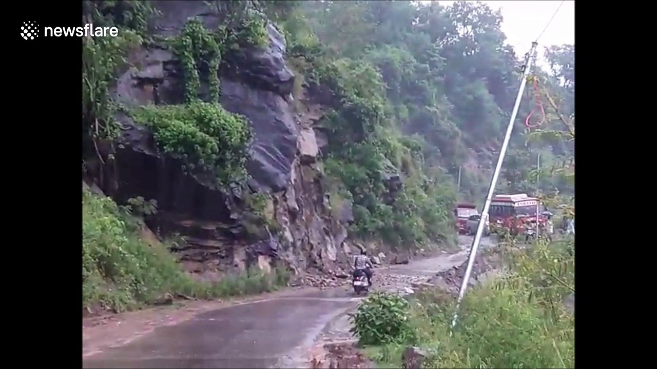 Close call: motorcyclist avoids landslide by inches