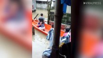 Children Use Boat After Rain Flooded Their Homes