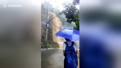 Water cascades down mountainside during Philippines floods