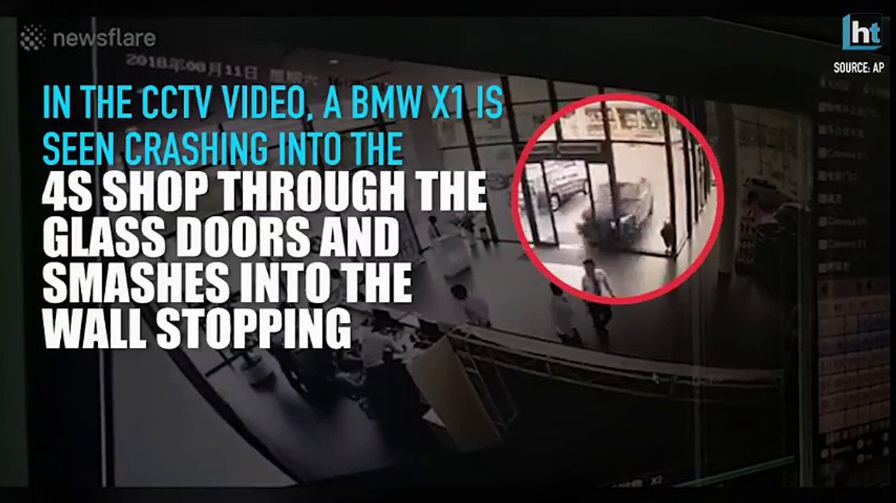 Watch__CCTV_footage_of_a_woman_crashing_BMW_into_a_4S_sho
