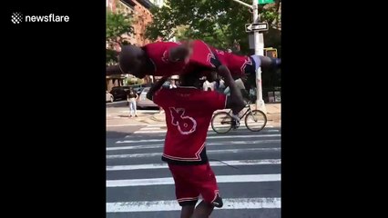 Man spins on twin brother's head in amazing workout stunt
