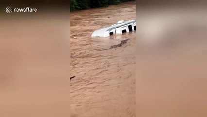 Camper van floats down overflowed Fishing Creek