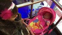 Little Girl Pushing Pink Stroller in Shopping Centre