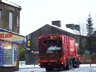 Dustbin lorry stuck in the snow