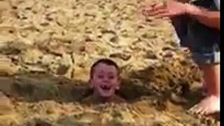 Little boy gets stuck in sand