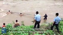 Hanging by a thread! An elderly woman was rescued amid torrents in a flooded river.