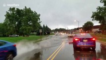 Cars slosh through floodwaters in Madison