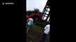 Water tank collapses and crushes digger in demolition fail
