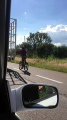Bicycle Rider Holds onto Truck Tailgate