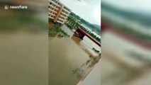 Lorry carries students across flooded campus to station