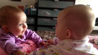 Twin babies talk and hold hands for the first time