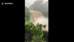 Tranquil waterfall turned into raging cascade of floodwaters as Hurricane Lane intensifies