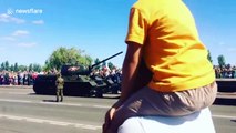 Russian tank embarrassingly barrel rolls off trailer during parade